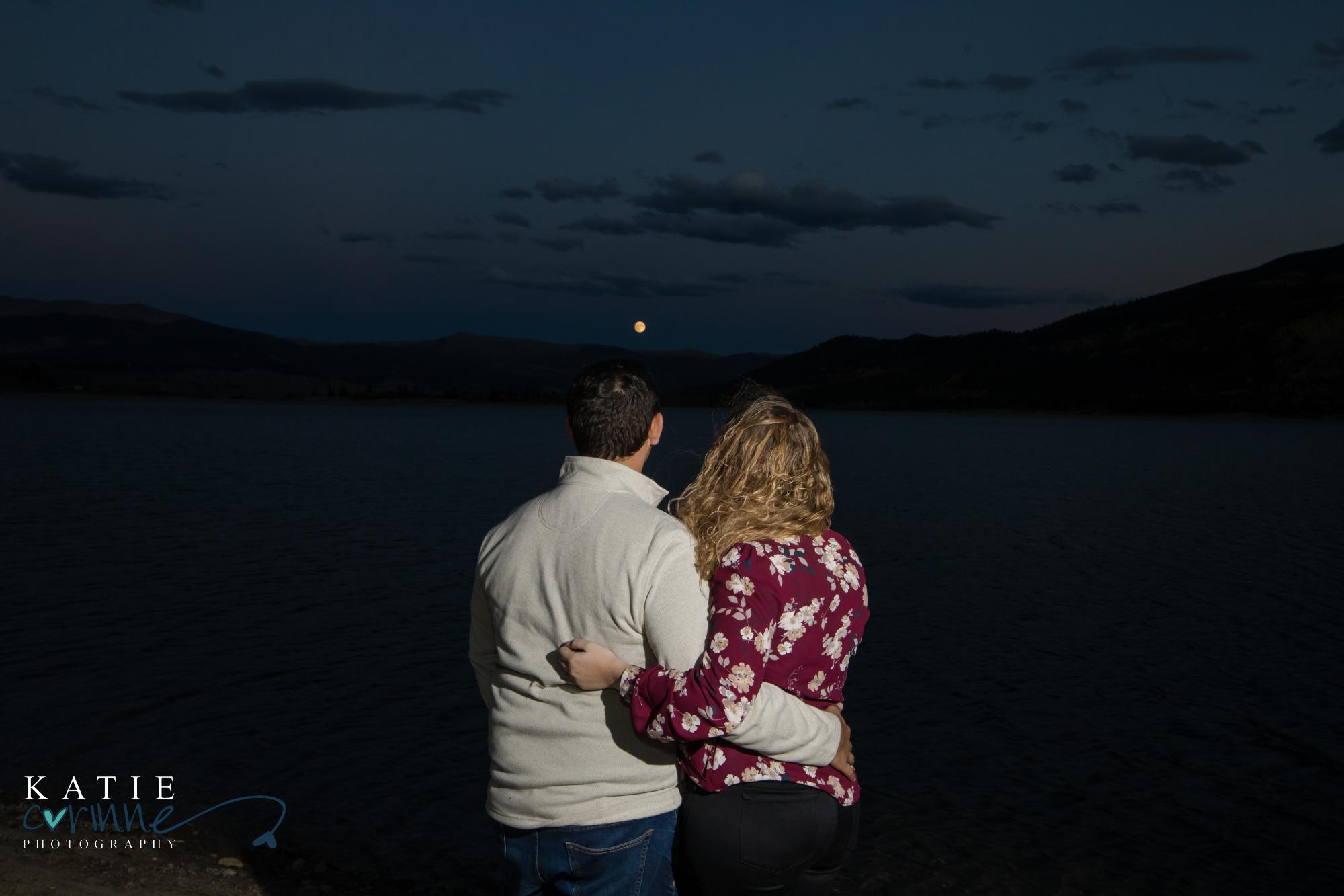 Colorado engaged couple watch moonrise over Rocky Mountains