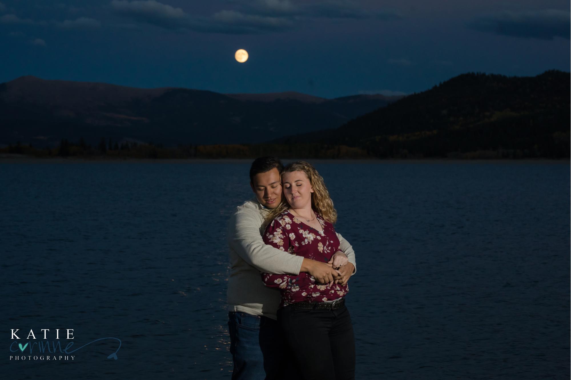Engaged couple in Colorado as moon rises