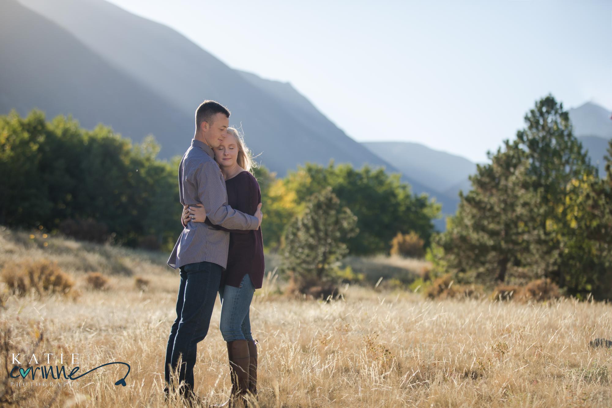 Engaged couple in front of Colorado mountains