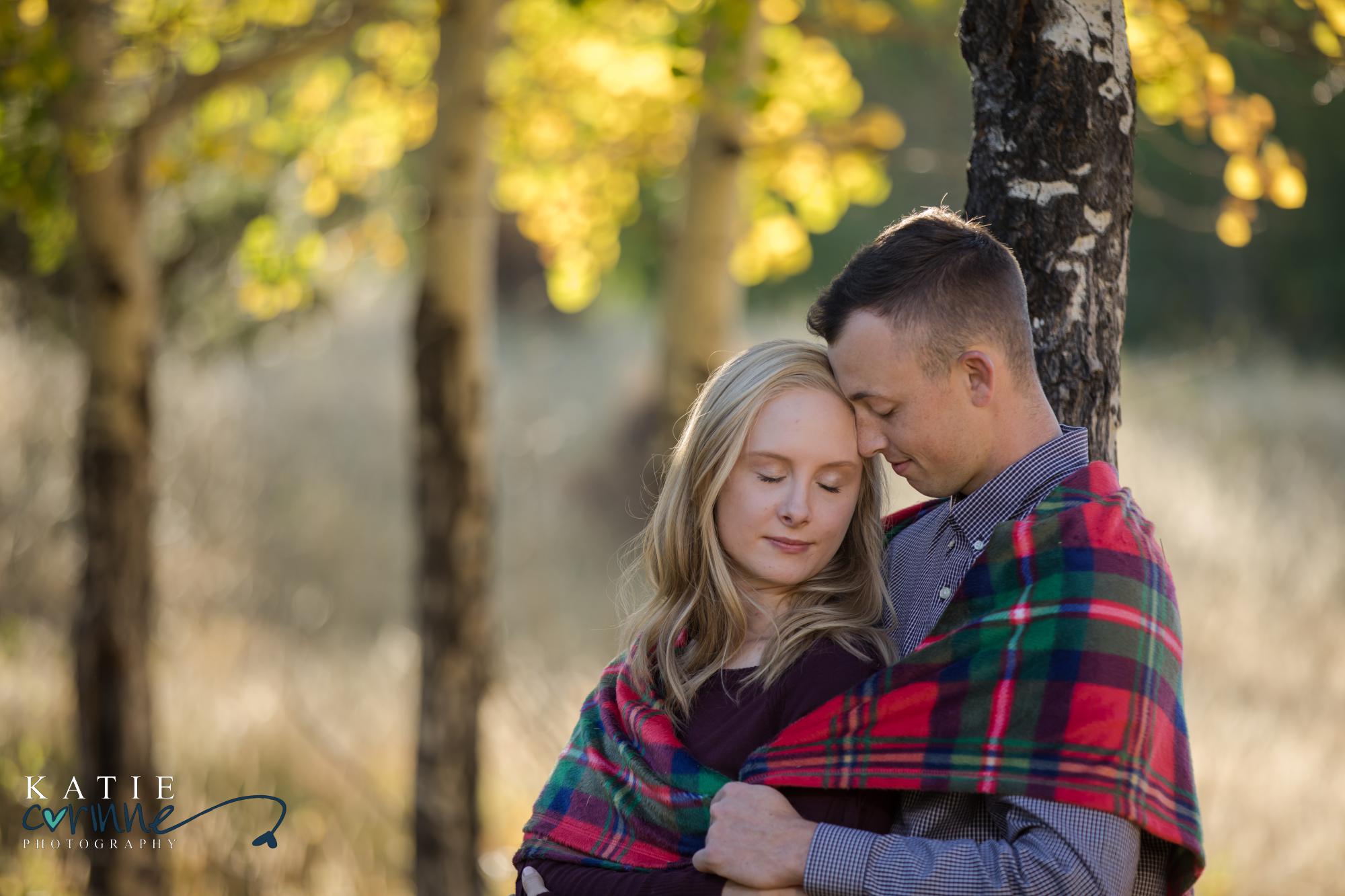 Colorado engaged couple in front of fall leaves