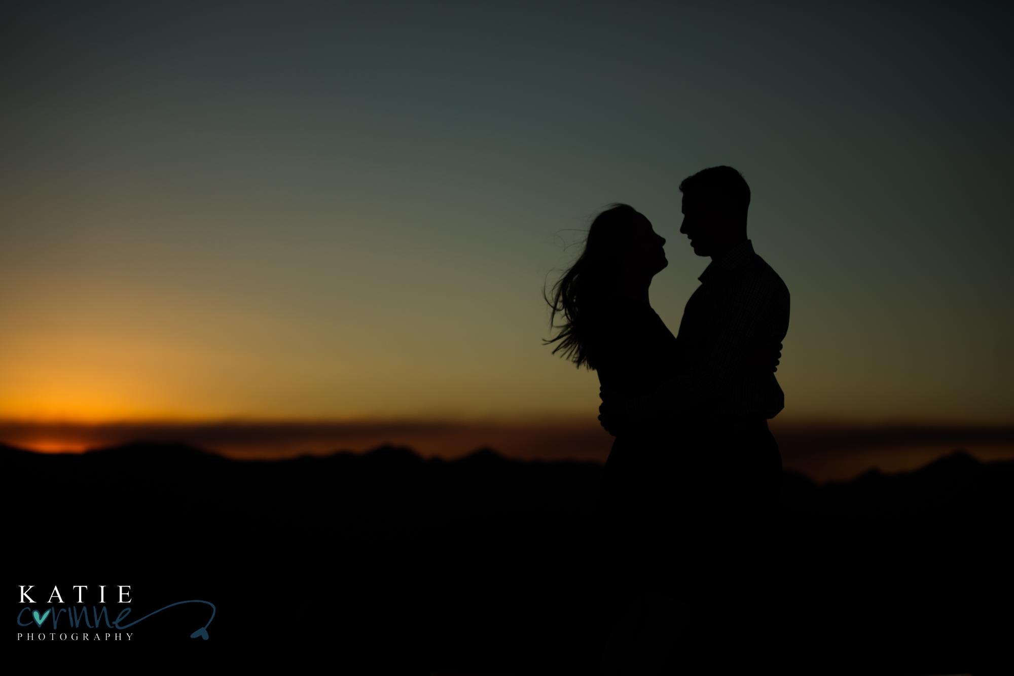 Colorado engaged couple pose in front of sunset