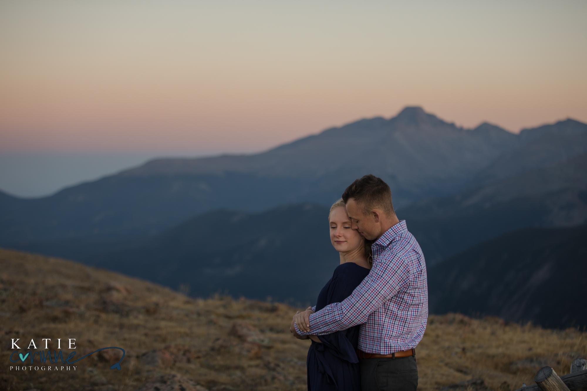 Colorado engaged couple pose in front of mountains