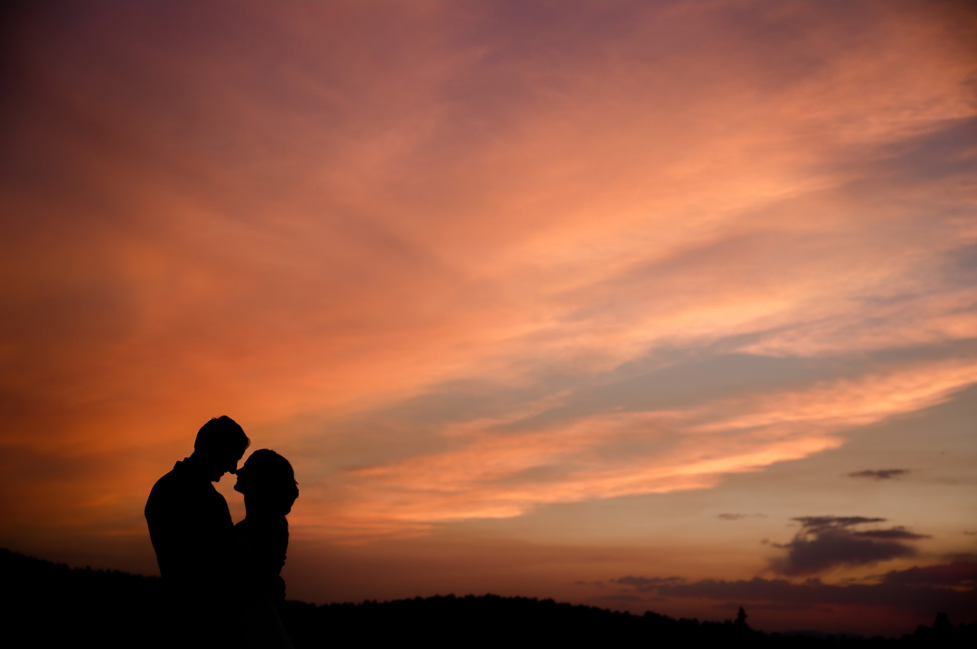 Christian wedding couple against colorado rocky mountain sunset