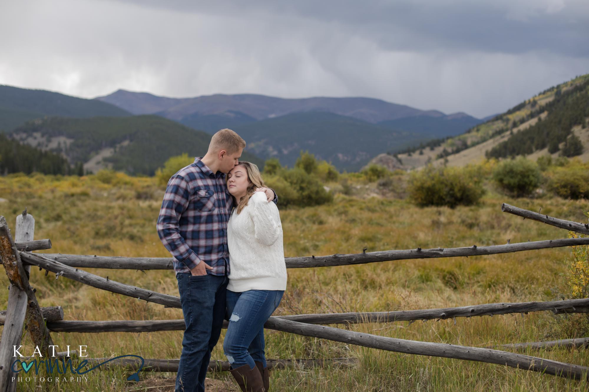engaged couple in front of rocky mountains