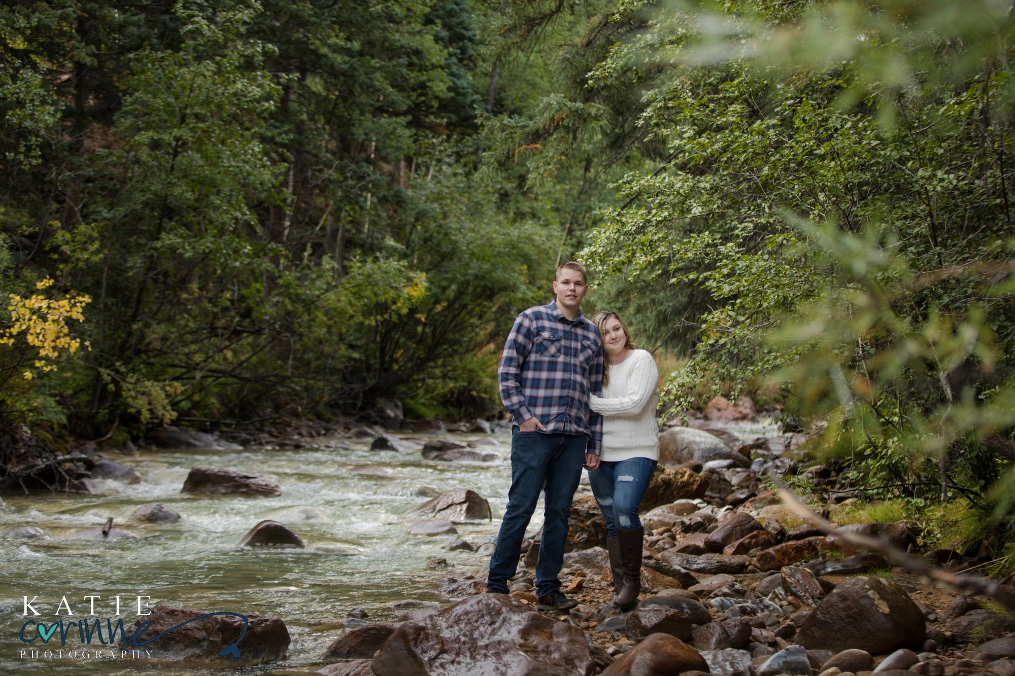 couple by stream at colorado fall engagement