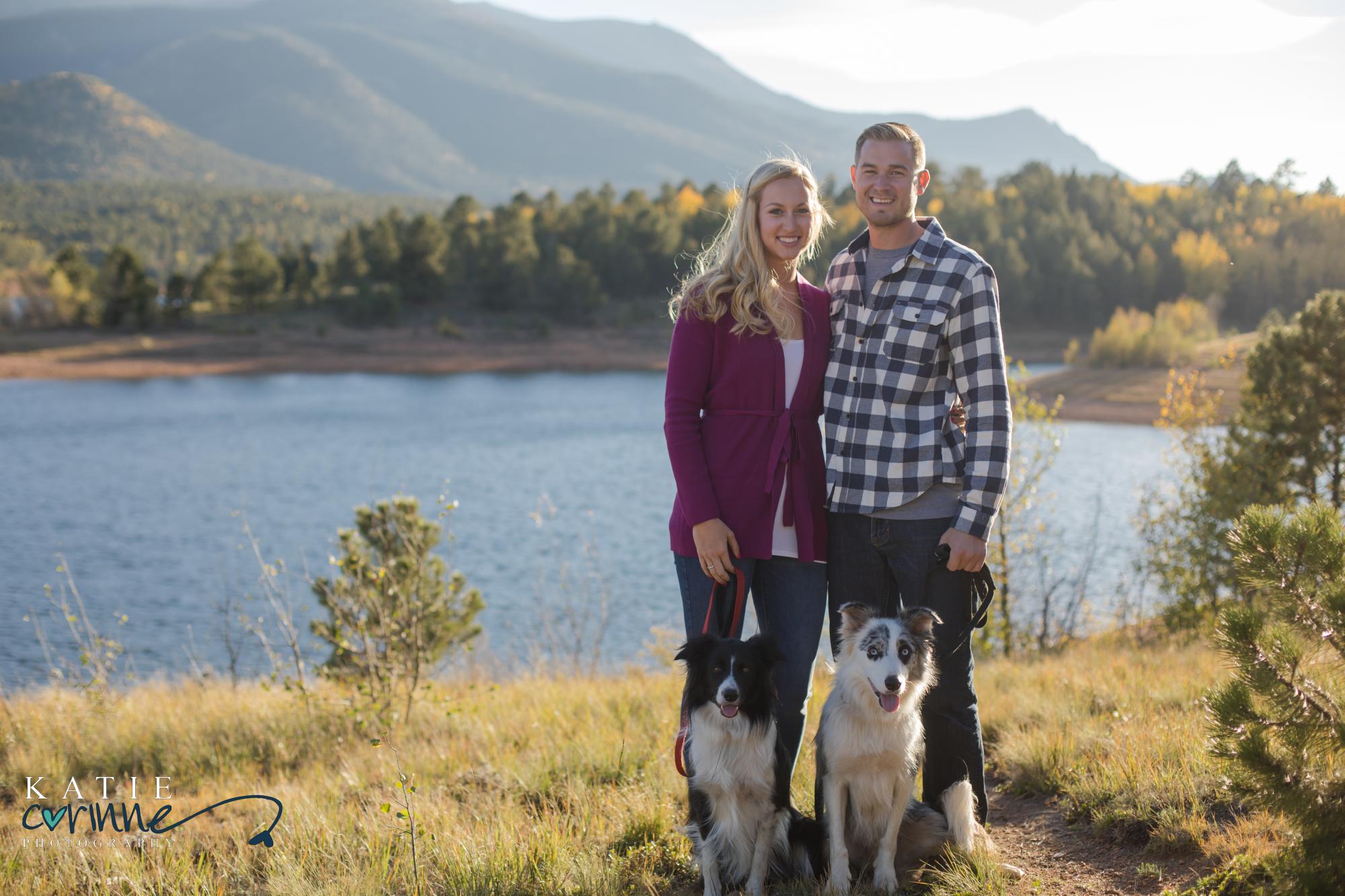engaged couple with dogs on Pikes Peak