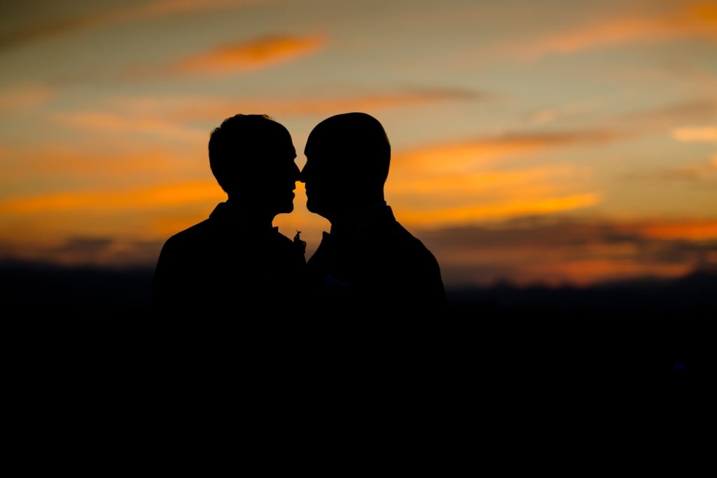 Newlywed couple in front of Denver sunset