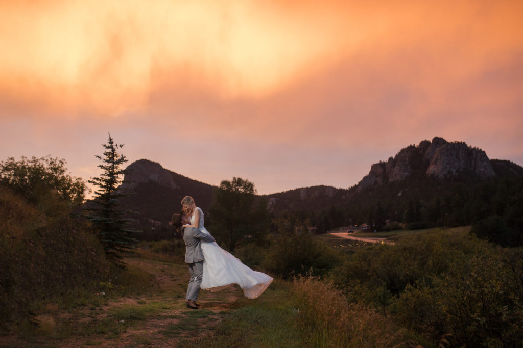 Bride and Groom hugging in the mountains at sunset