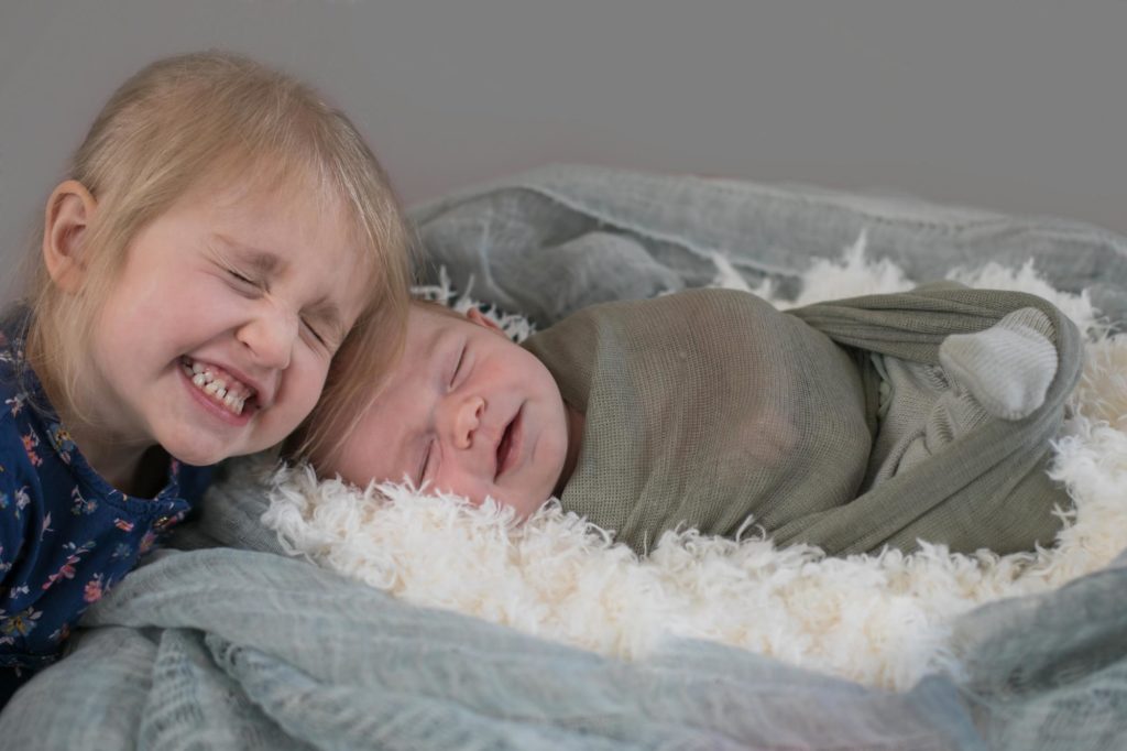 newborn boy with his big sister