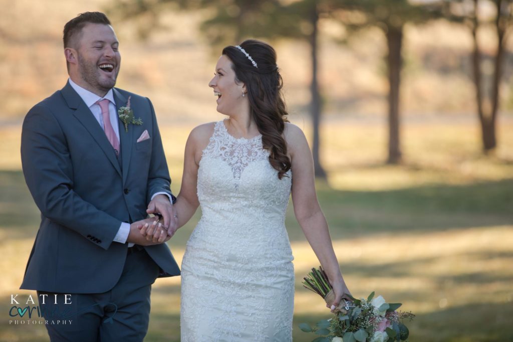 Colorado bride and groom laughing together after ceremony