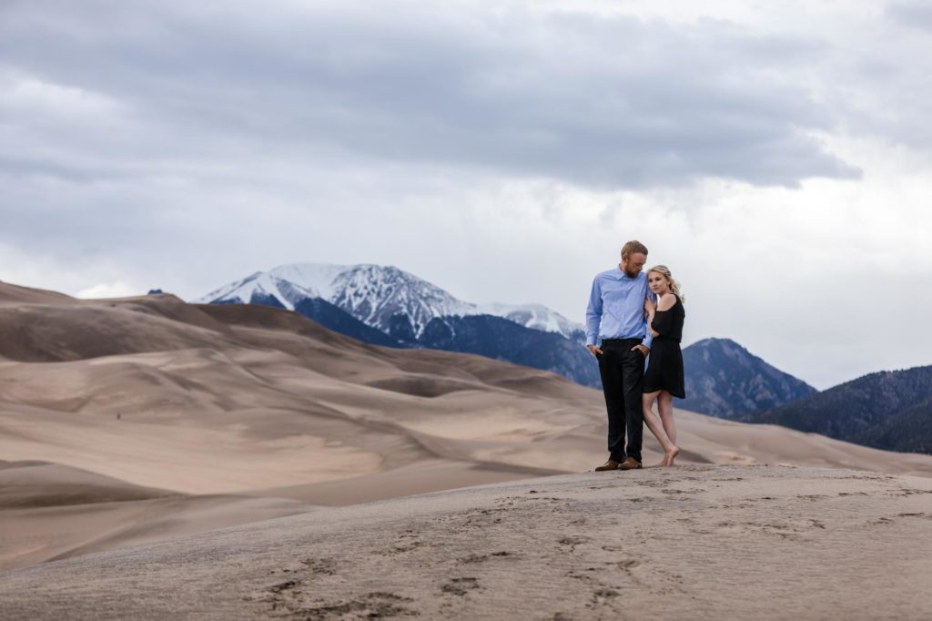 Couple poses in Colorado sand dunes
