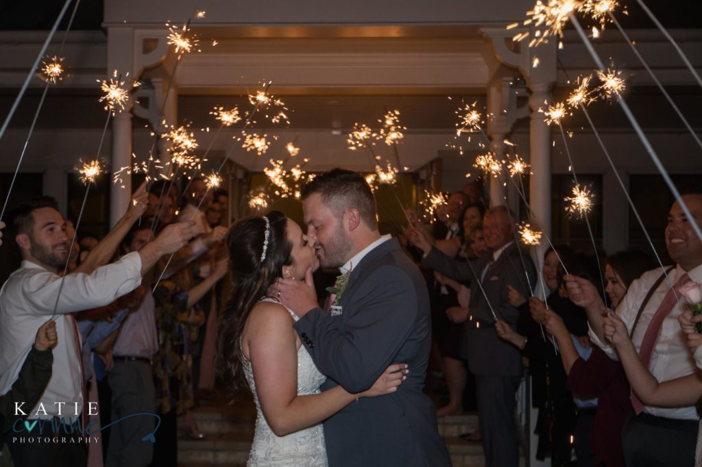 Couple kisses during sparkler exit at Larkspur Colorado wedding