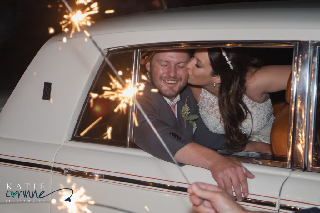 Married couple in car during sparkler exit at Monument Colorado wedding