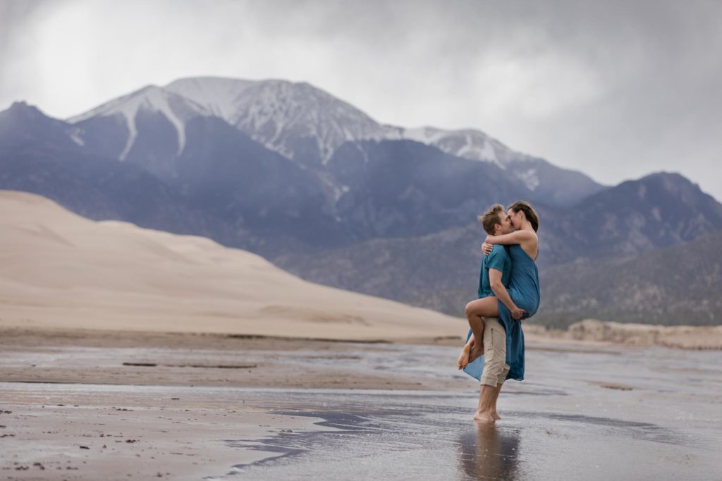 Couple kisses at Colorado Sand Dunes