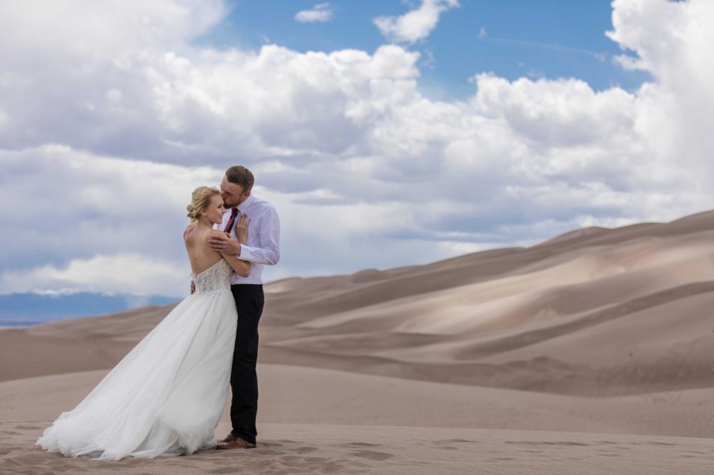 Colorado couple holds each other at sand dunes
