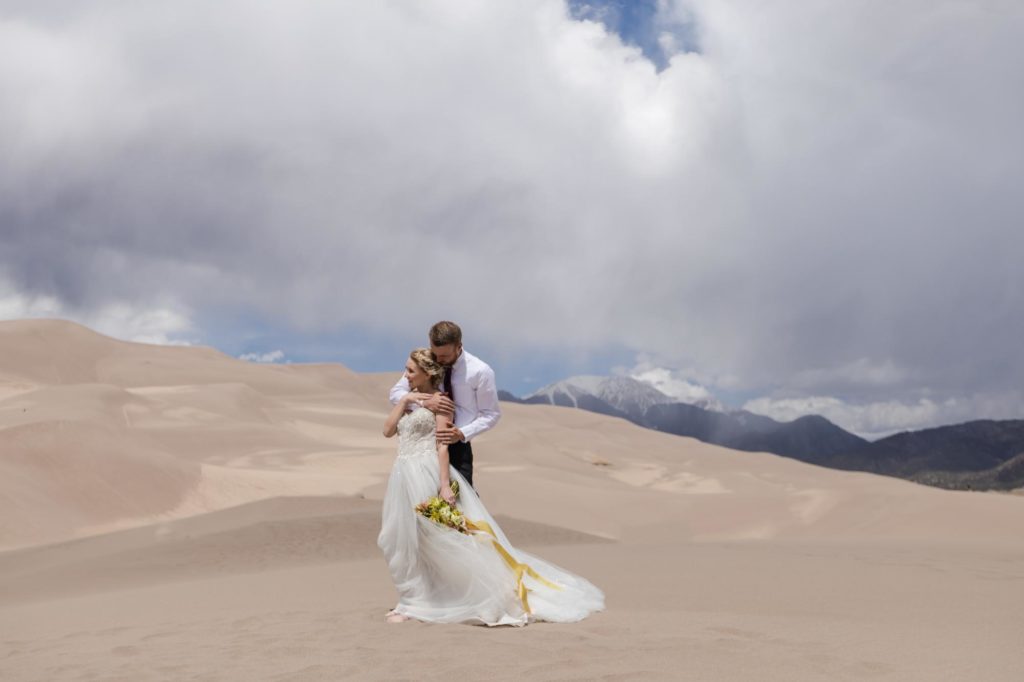 Colorado couple holds each other at Great Sand Dunes National Park