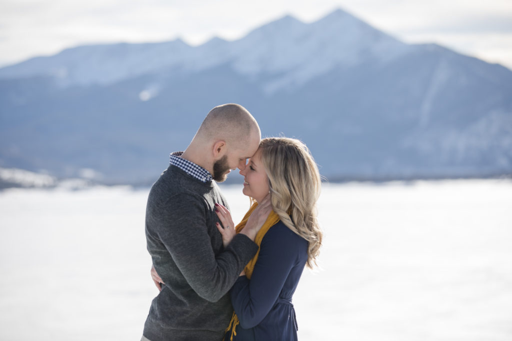 Engaged couple in front of rocky mountains