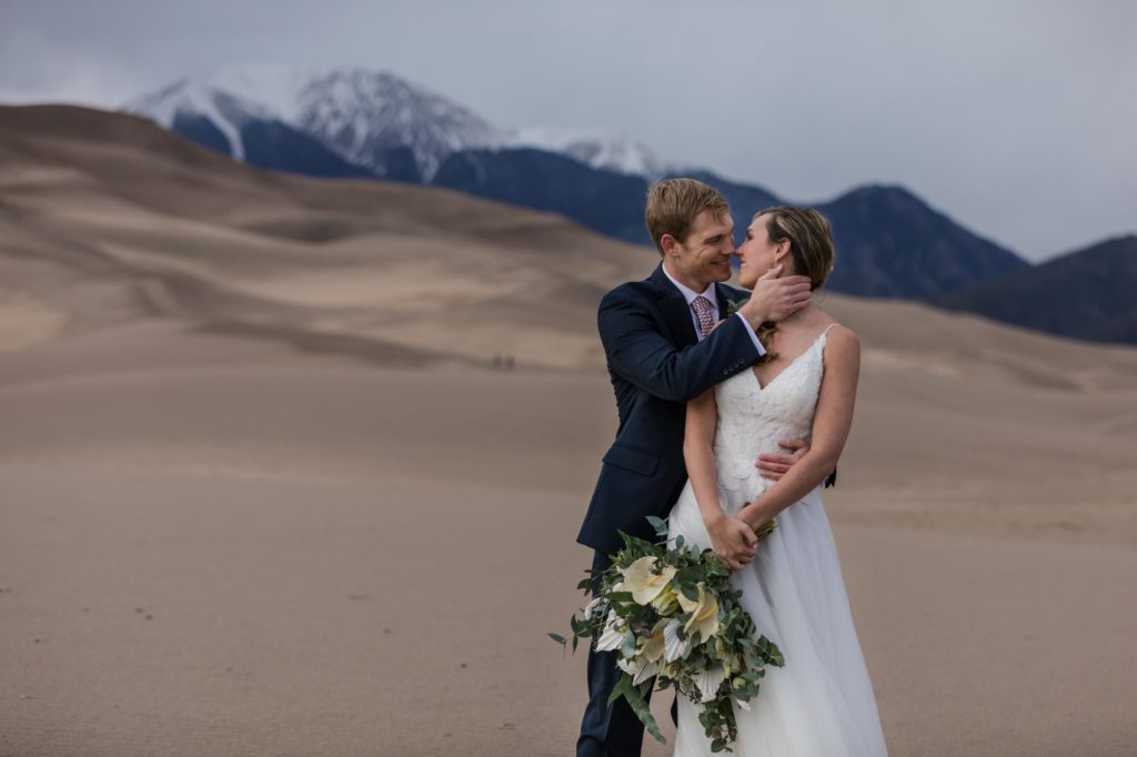 Couple in front of mountains on day after wedding