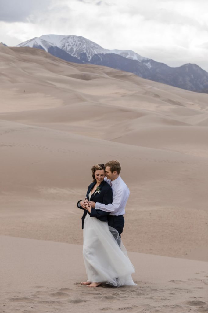 newly married Couple in front of mountains on day after wedding
