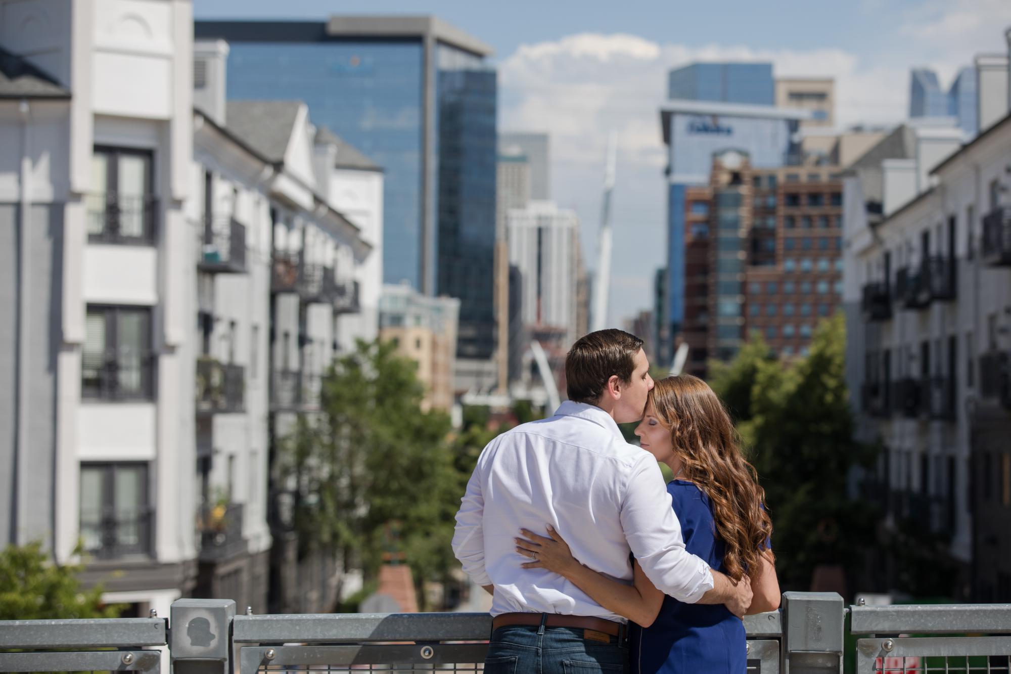 engaged couple overlooks downtown Denver