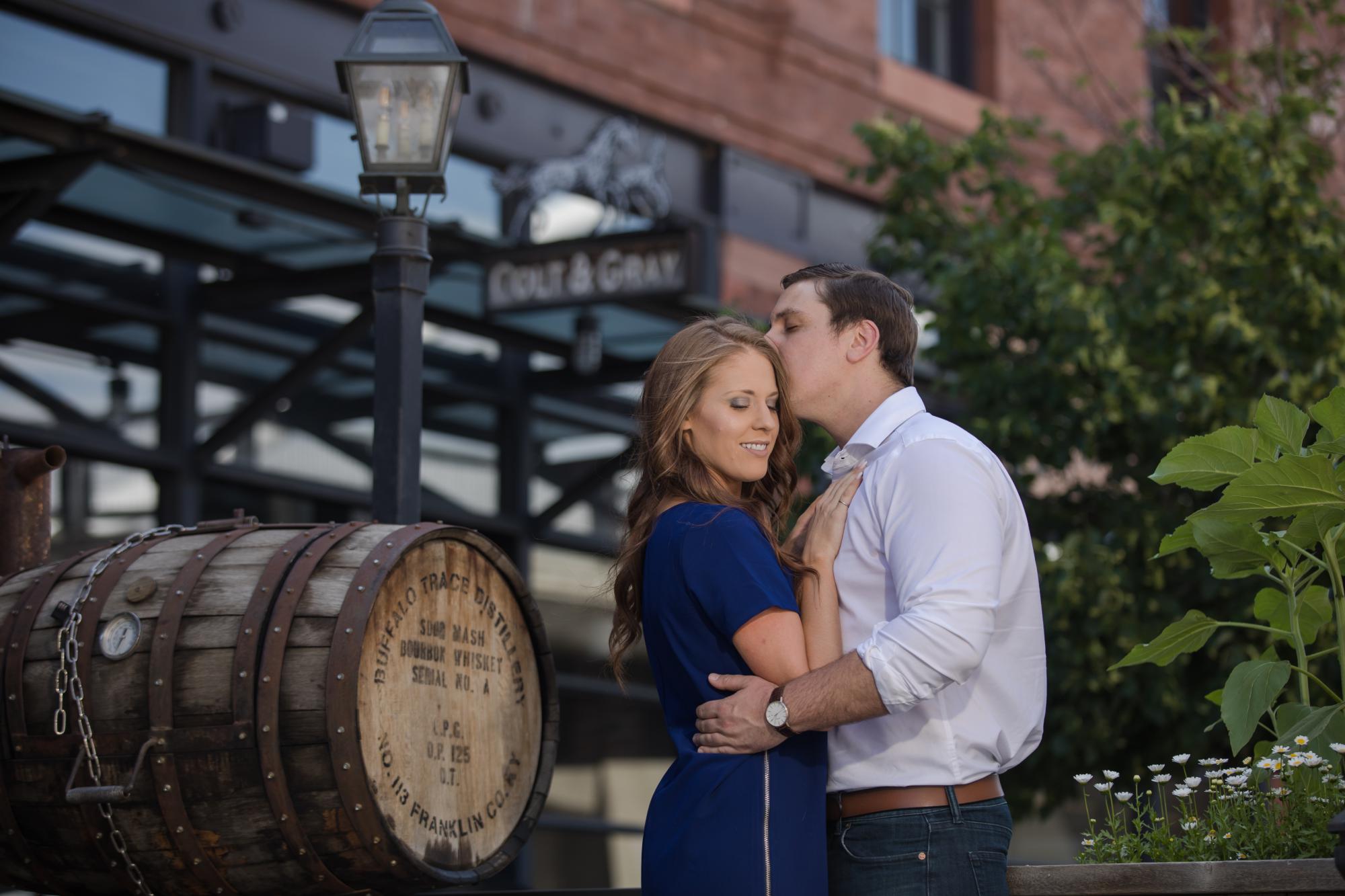 Couple kisses in front of distillery