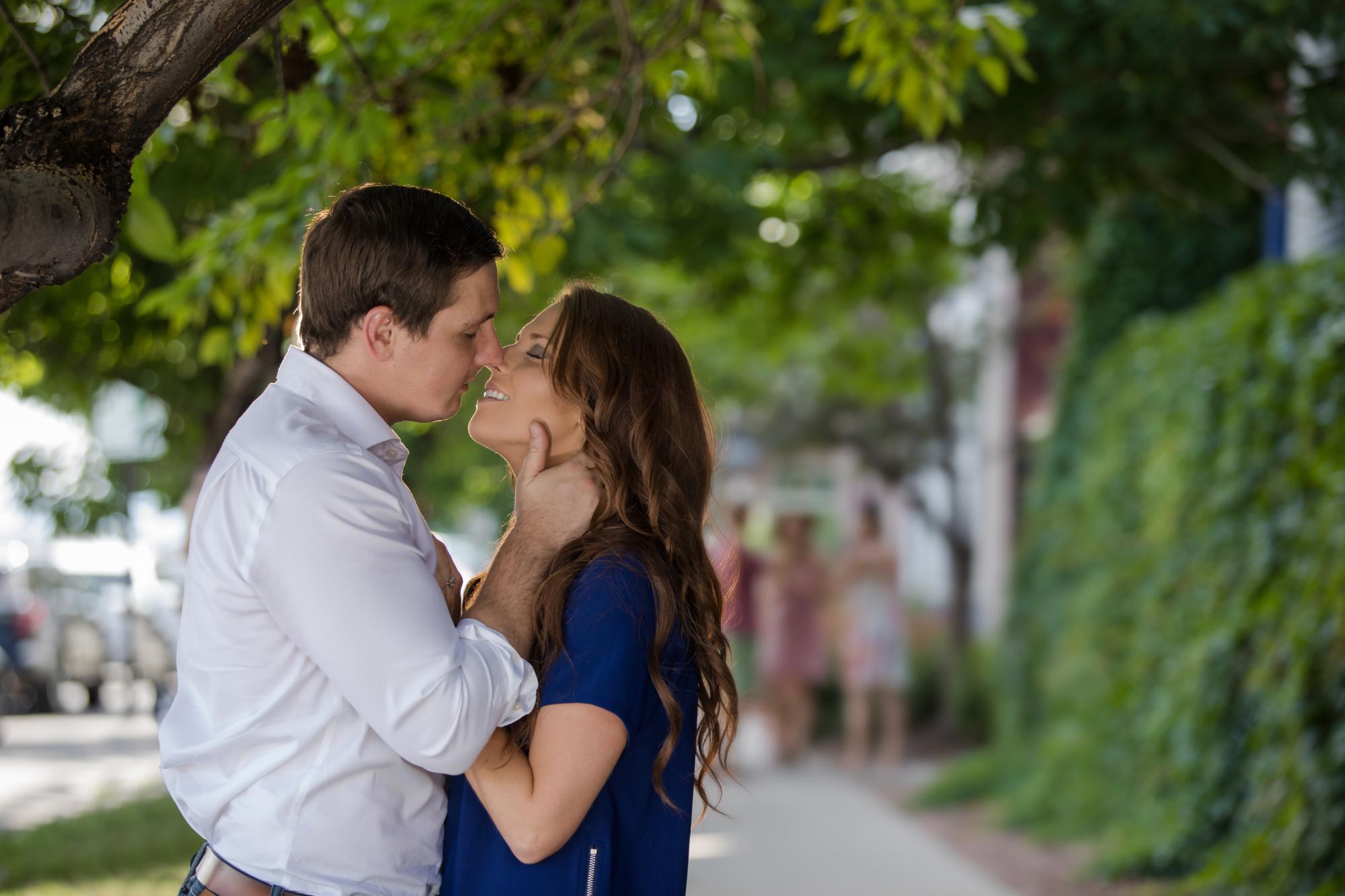 Couple kisses under trees in LohI