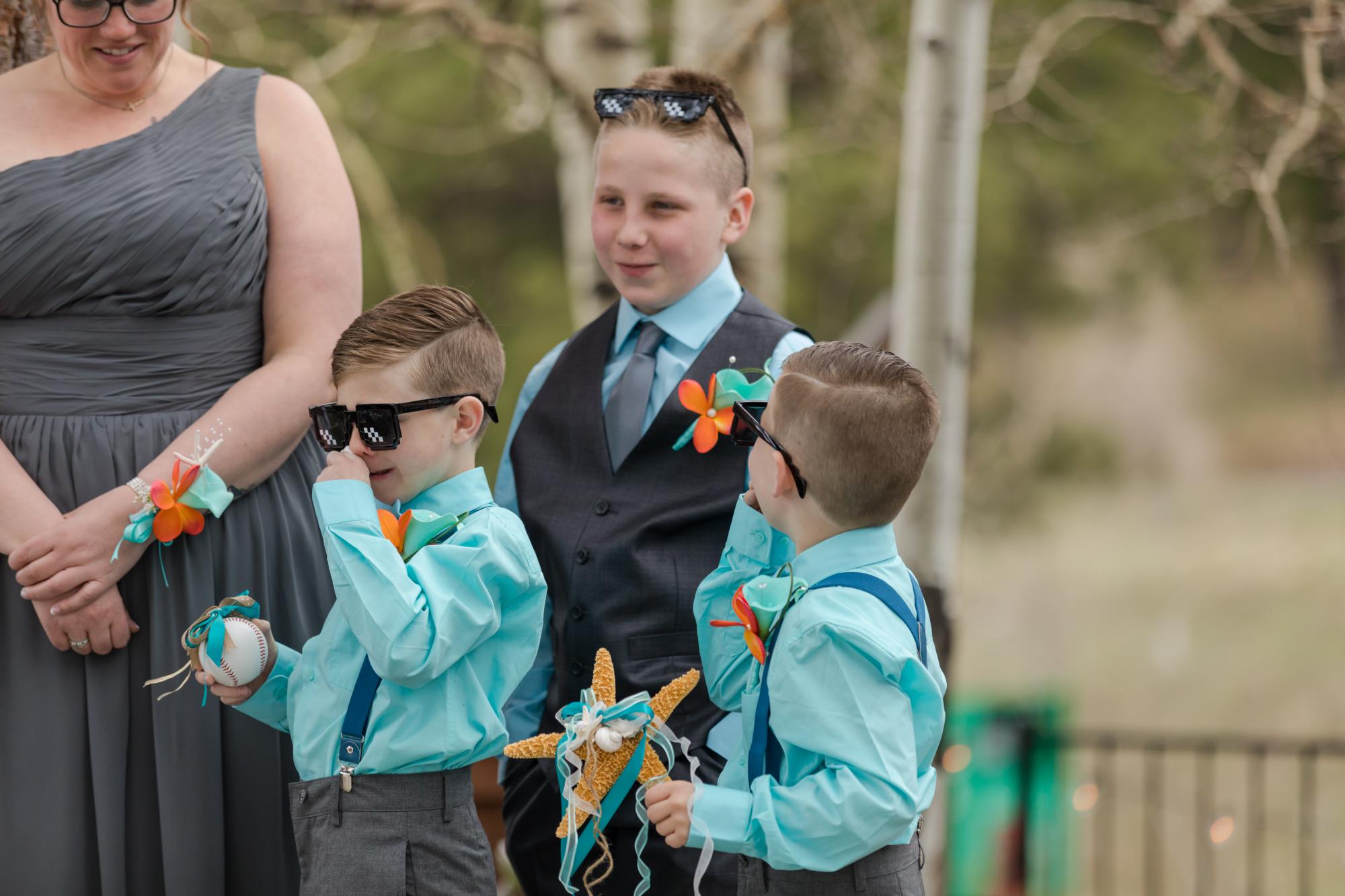ring bearers play during Evergreen wedding ceremony