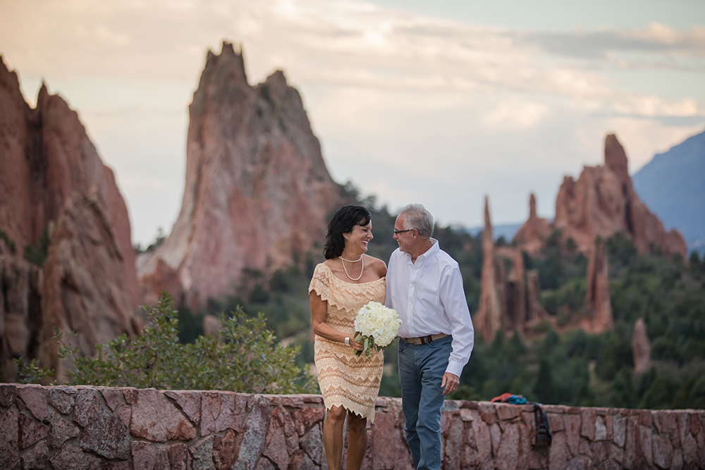 couple pose for photographer at garden of the gods