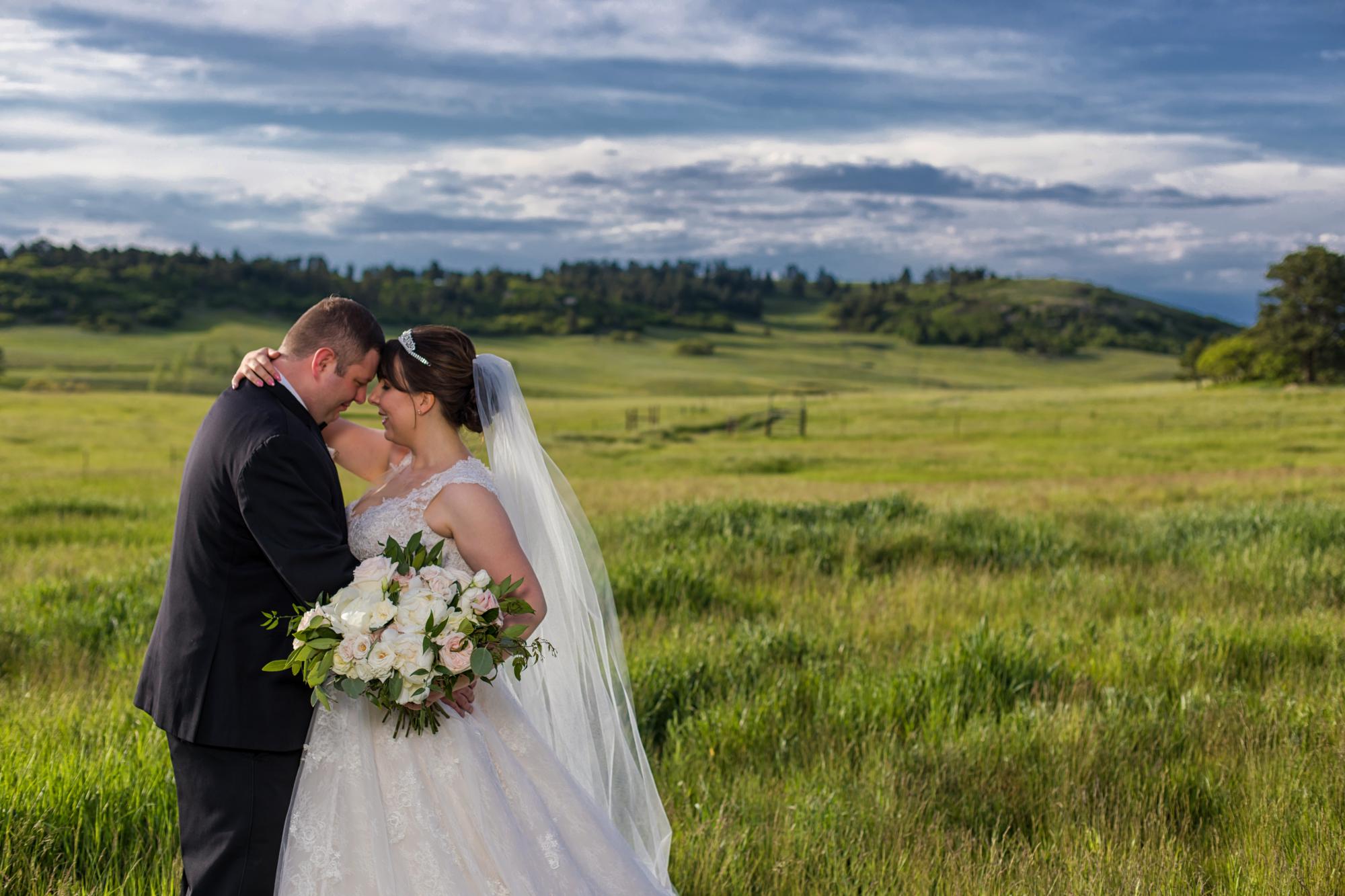 newlywed couple pose for Colorado wedding photographer
