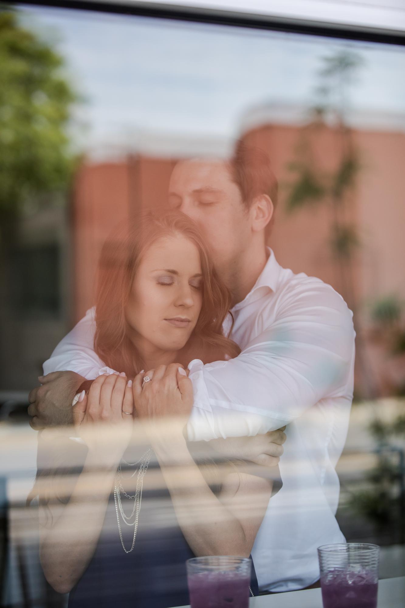 Couple kiss through window at Denver engagement session