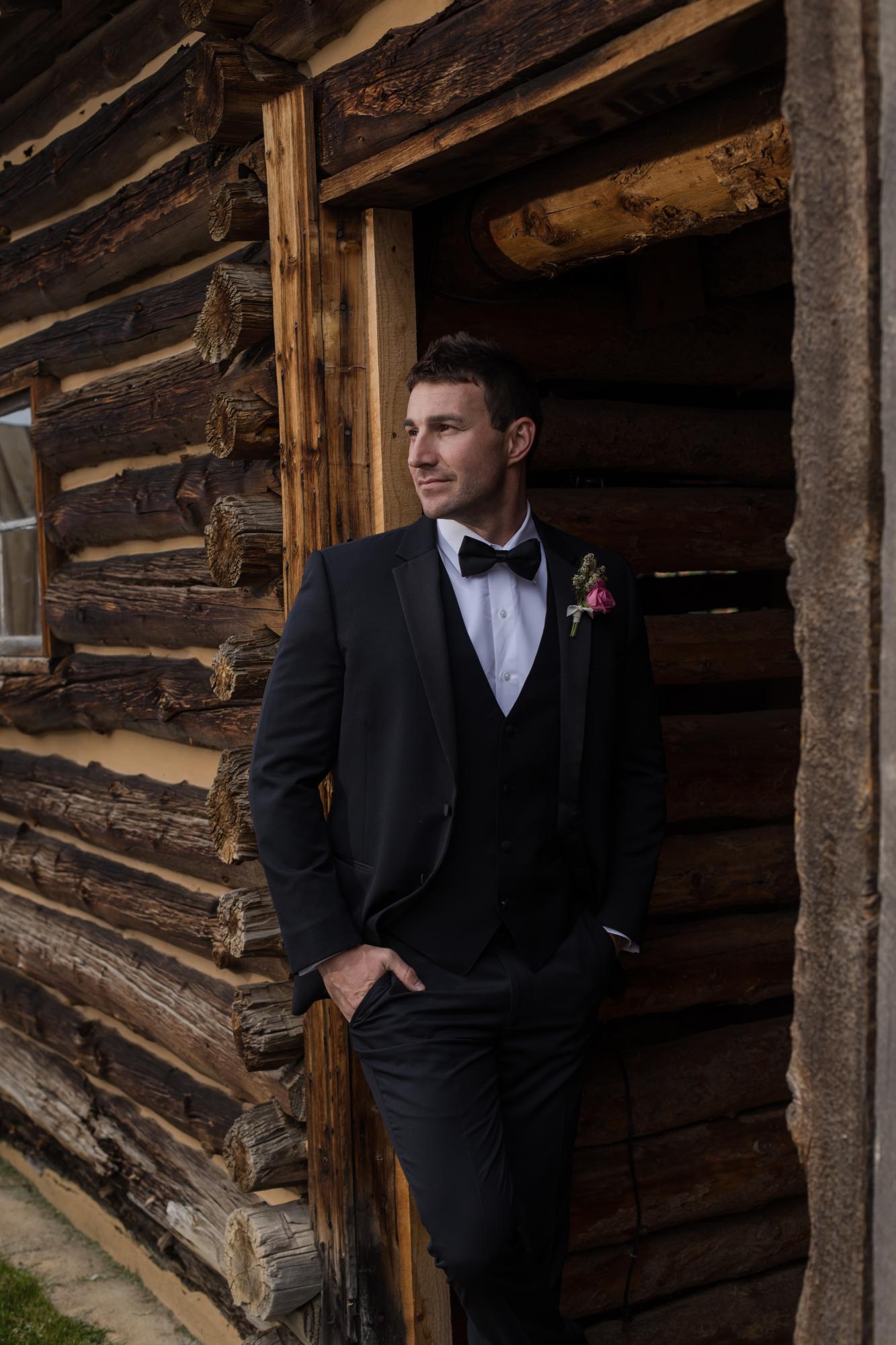Denver groom at rustic Colorado wedding venue