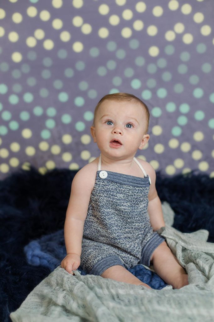 six month old baby in studio for milestone photos
