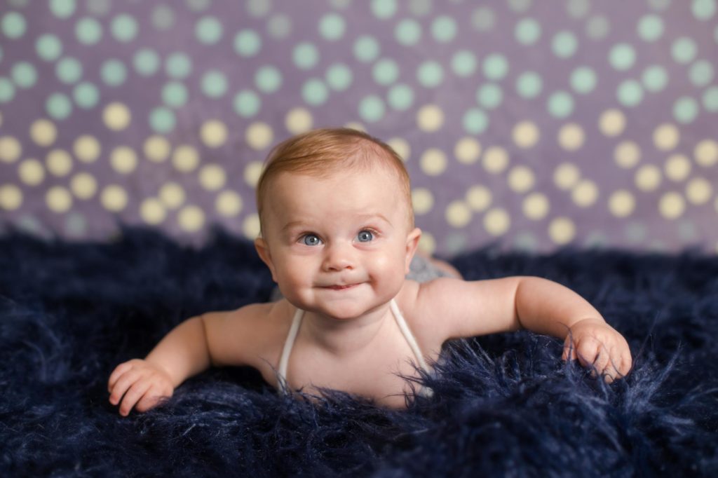 baby rolls onto belly for Colorado family photographer