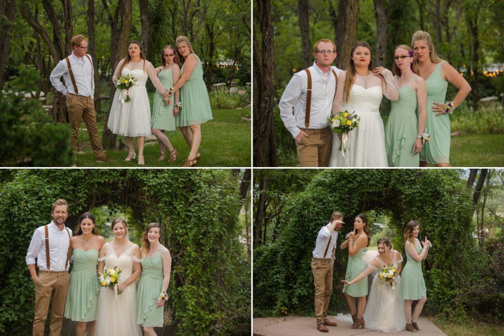 Wedding party poses in front of vines