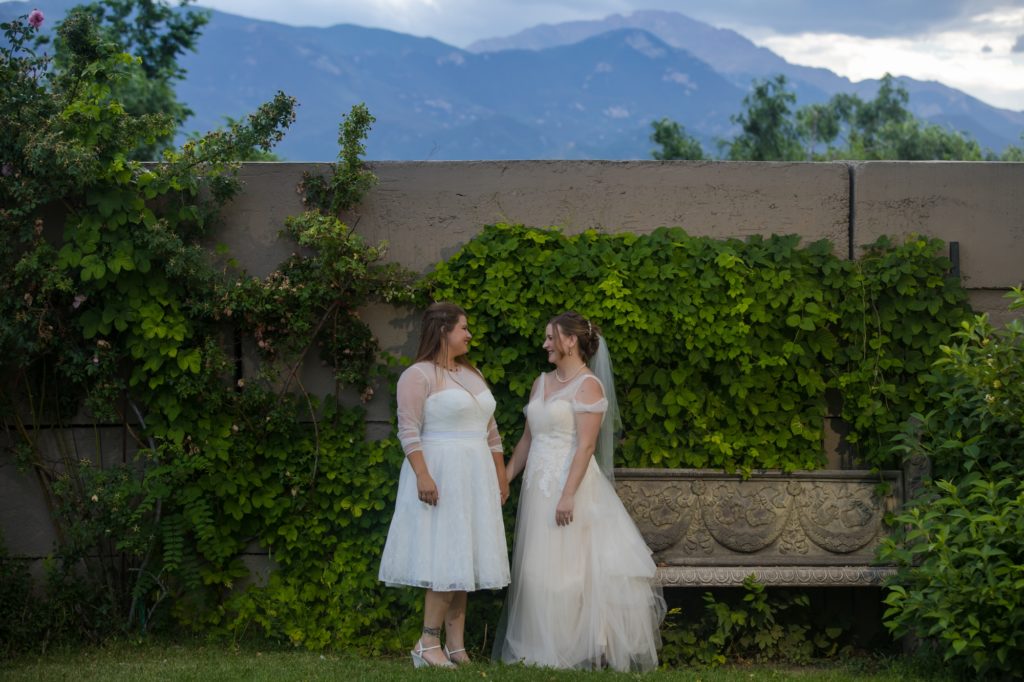 Colorado couple in front of mountains at queer wedding