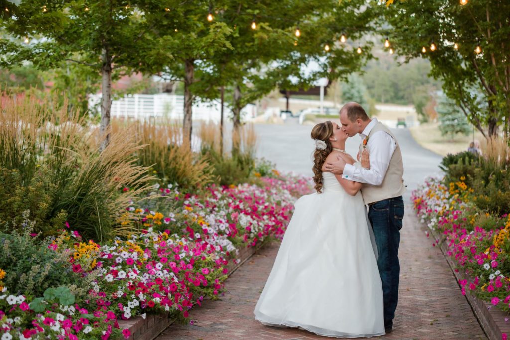 bride and groom kiss in the crooked willow garden
