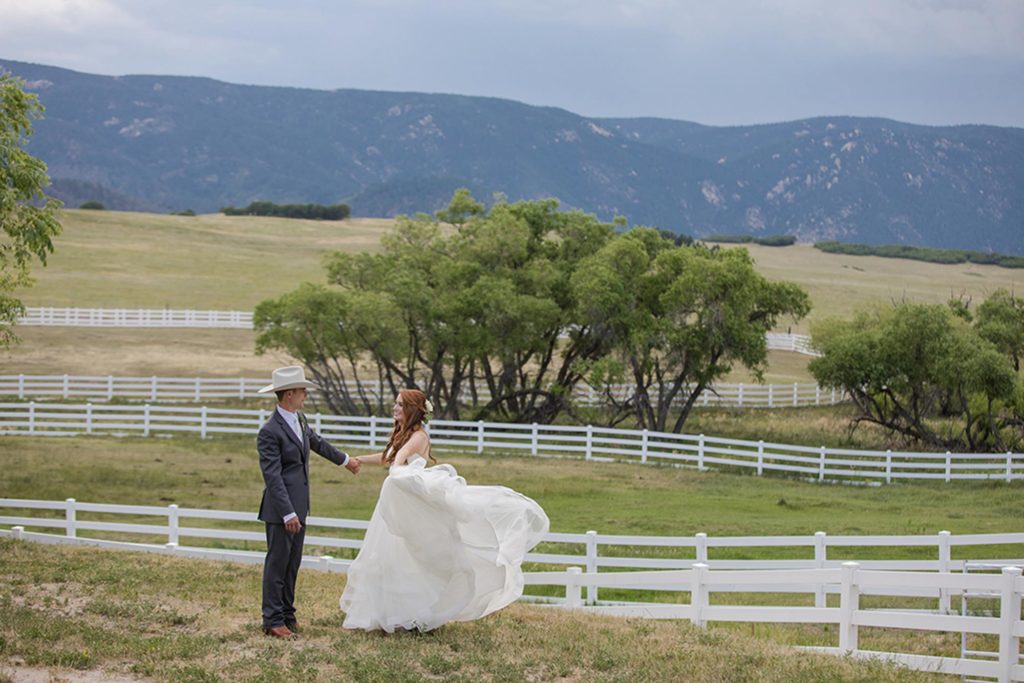 bride twirling in dress with horses in background