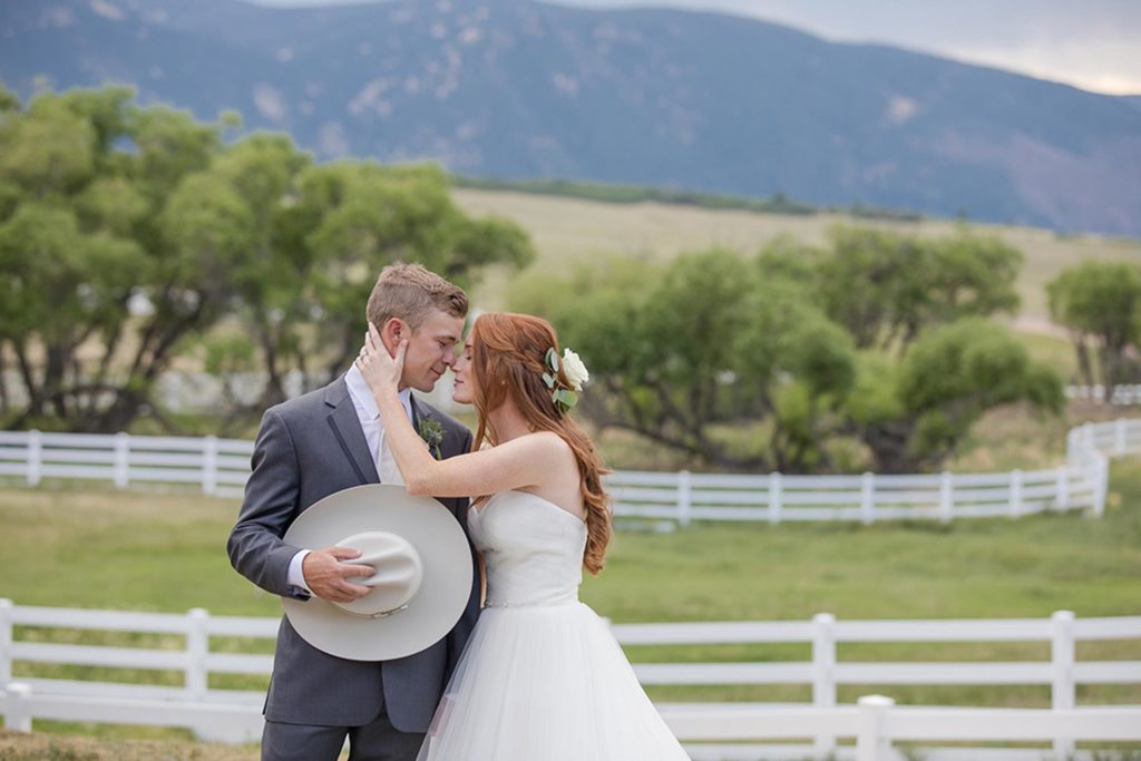 country groom with bride kissing