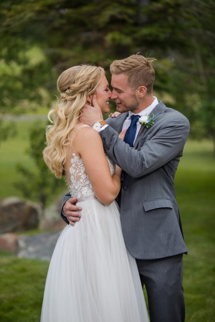 Bride and groom share a moment together at elegant Larkspur, Colorado wedding