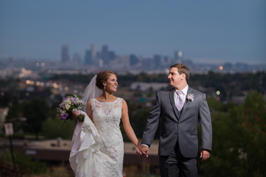 Bride and groom just married overlooking Denver skyline