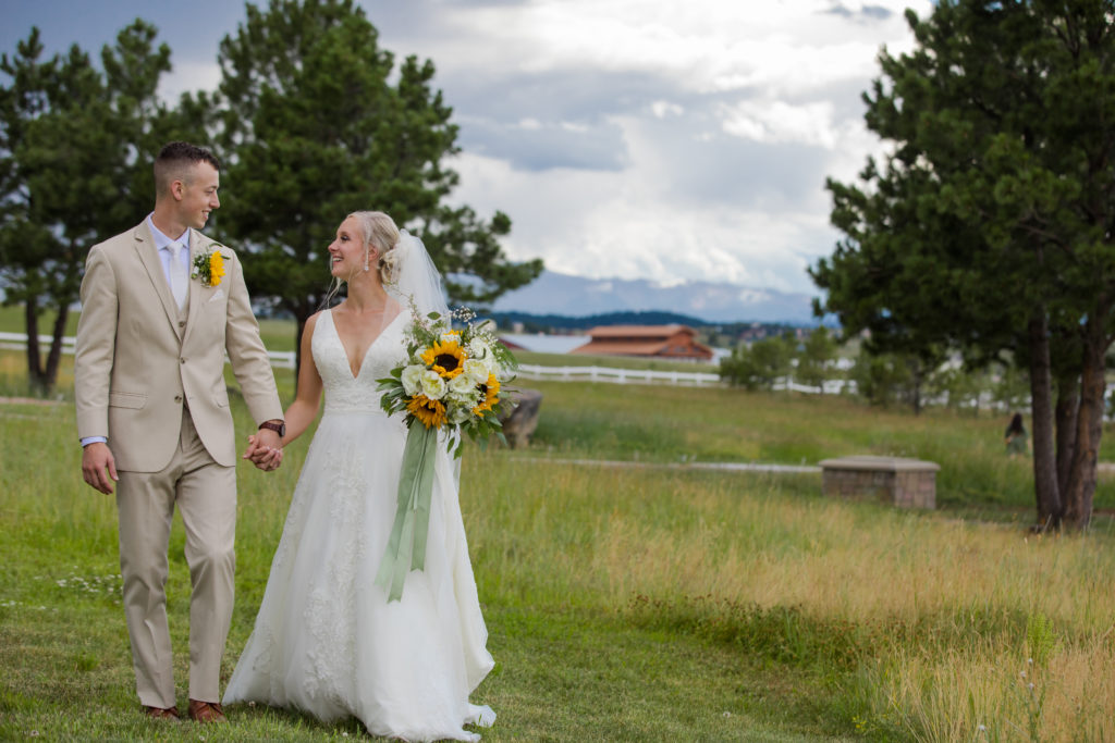 Newlywed couple poses for Colorado wedding photographers