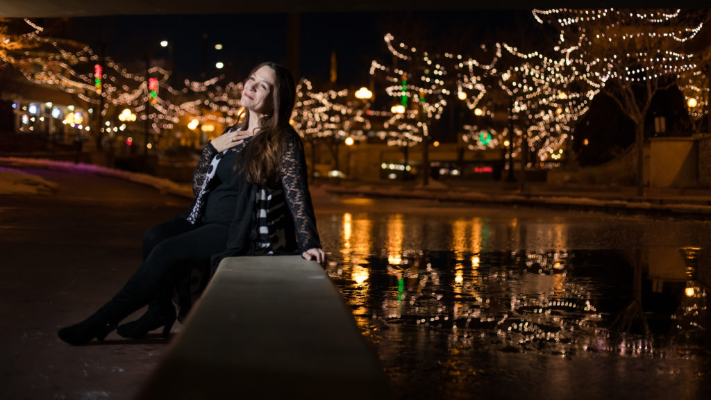 Woman poses in front of Pueblo Lights in Colorado