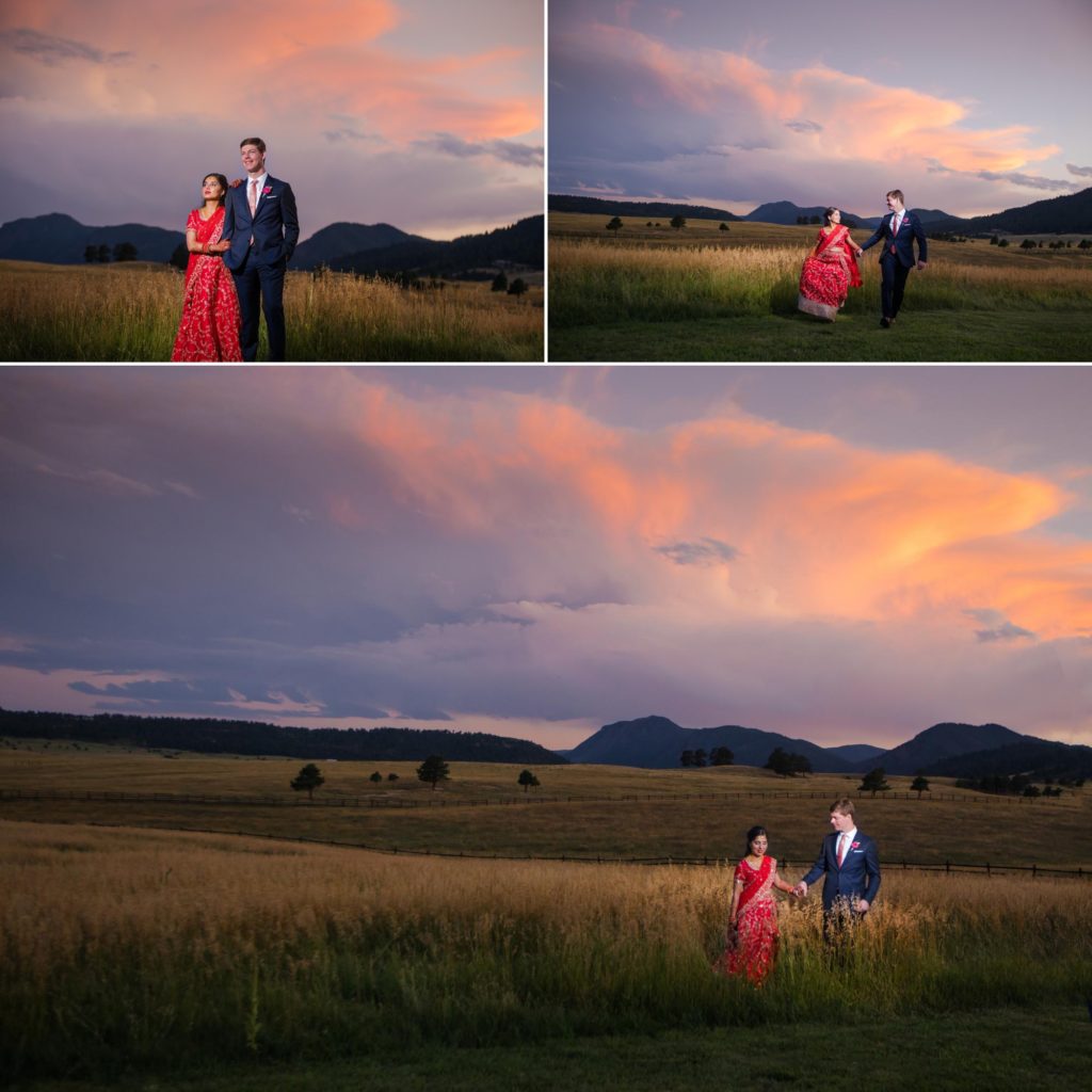 Newlyweds walk through fields in front of Rocky Mountain sunset