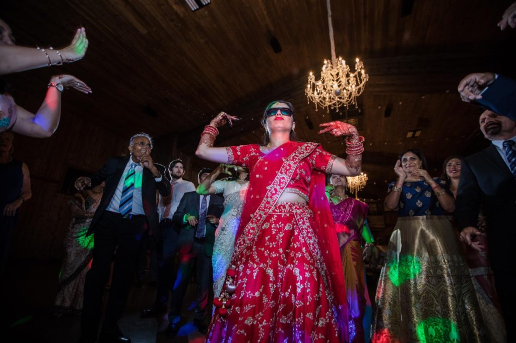 Bride wearing sunglasses dances at Spruce Mountain Ranch wedding reception