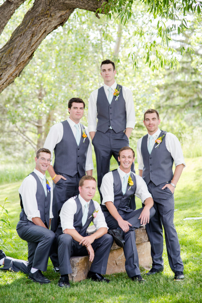Groomsman in vests at airy summer Spruce Mountain ranch weddings