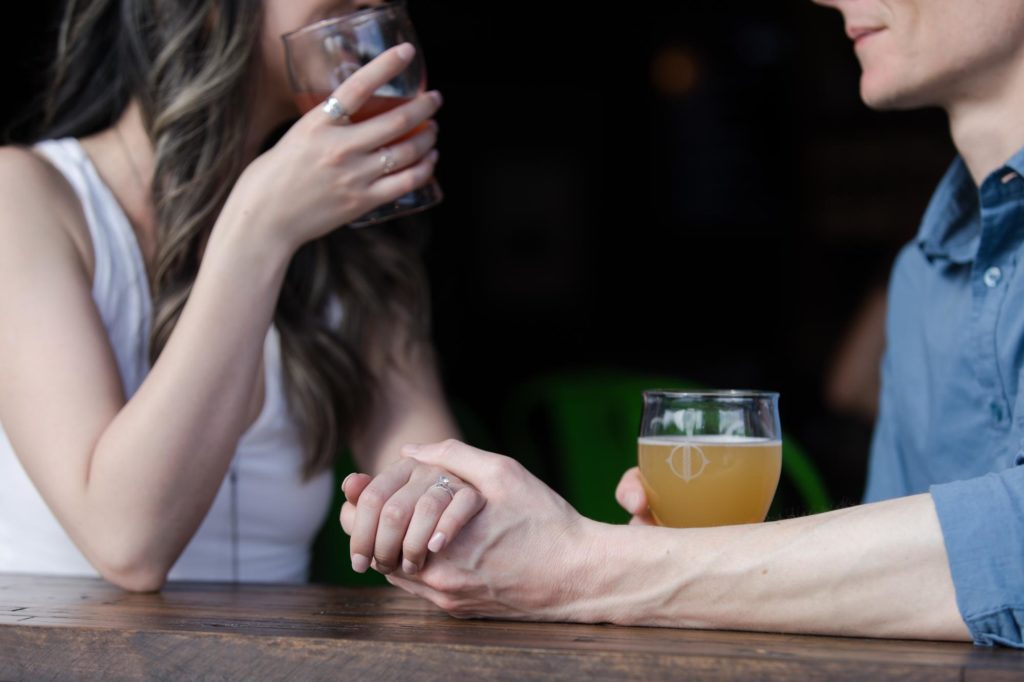 couple drinks beer during Denver engagement session