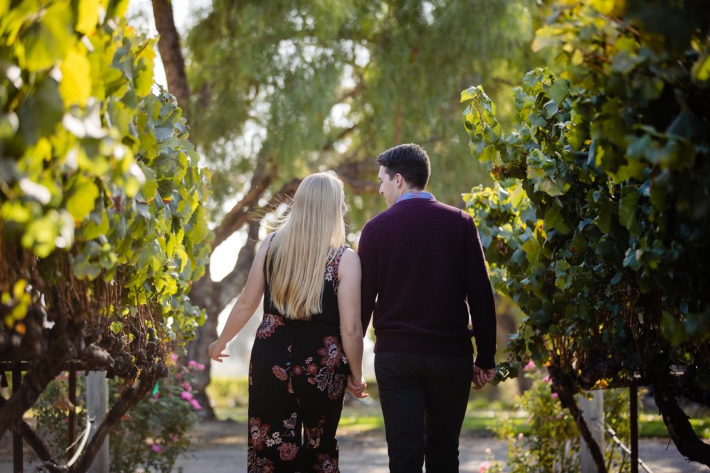 couple walks away from Santa Barbara engagement photographer