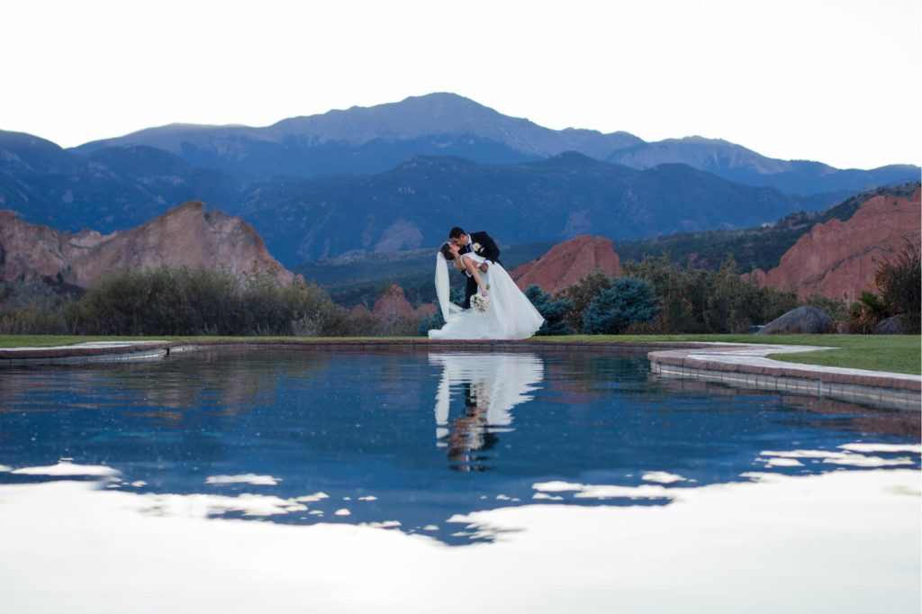 elegant Colorado Springs wedding couple in front of rocky mountains