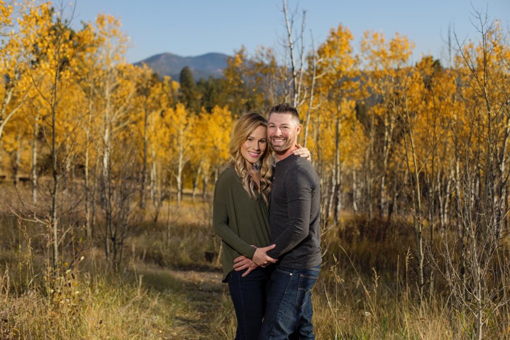 couple poses in front of rocky mountains