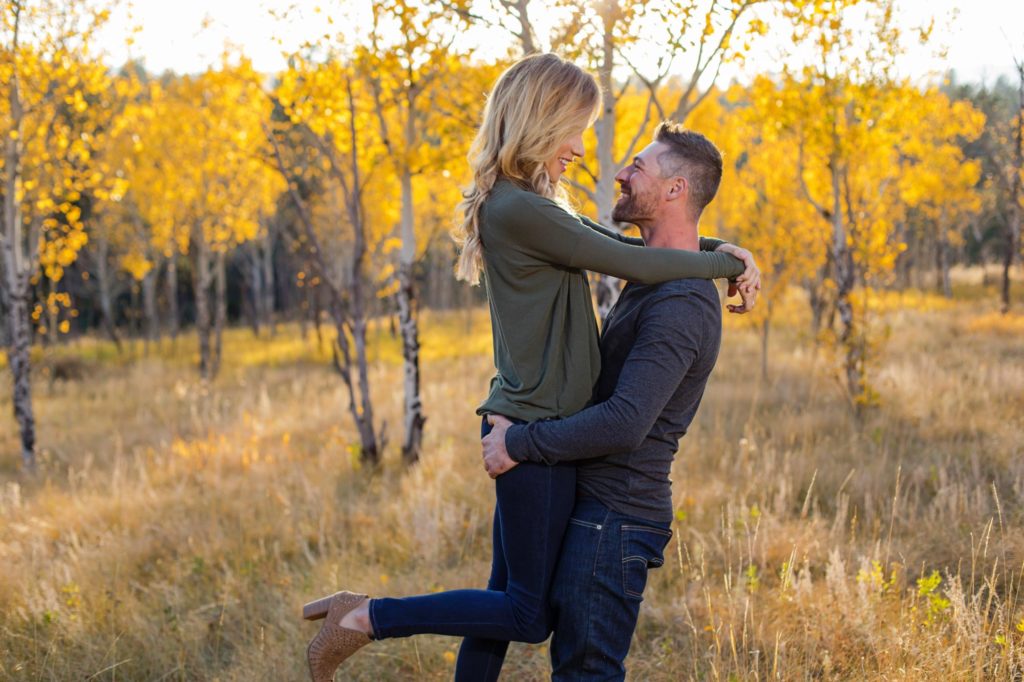 engaged couple in front of Aspen trees